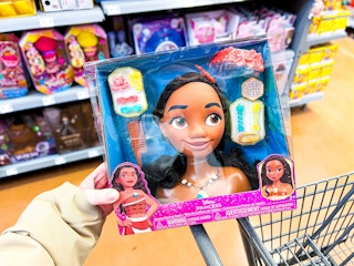 hand holding disney moana styling head on walmart cart