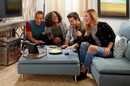 a group of friends in a living room playing an alexa game