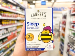 hand holding zarbees sleep tablets in walmart aisle