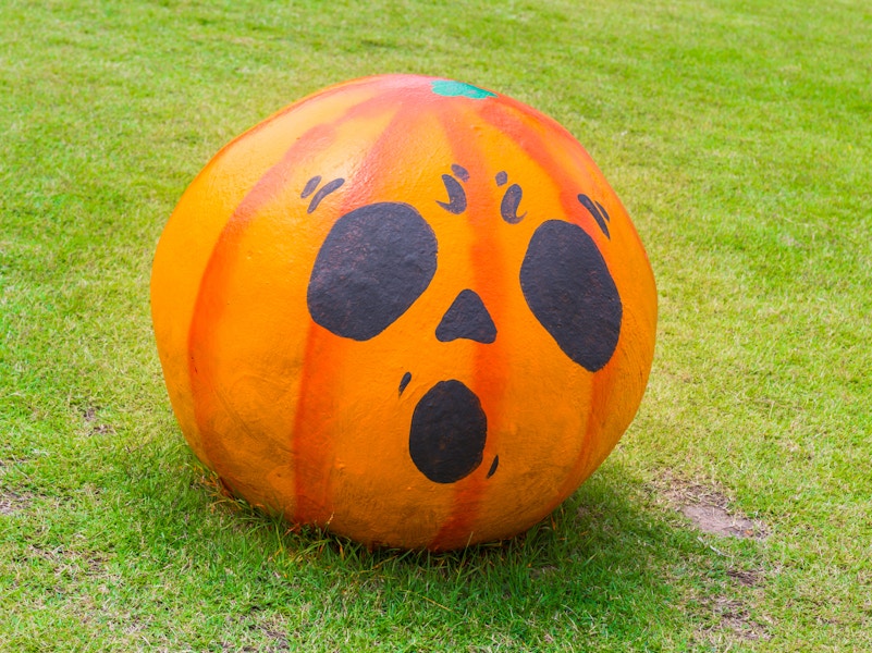 a pumpkin painted with a shocked face