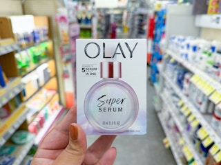 hand holding olay super serum in walgreens