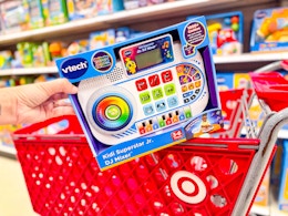 hand holding vtech dj mixer on target cart