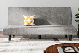 Lifestyle image of the DHP Kelra Armless Mid-Century Futon Sofa Bed in Light Gray Corduroy