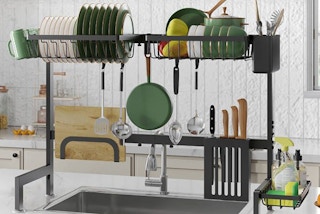 a dish drying rack sitting over a sink with dishes