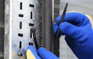 a zip tie being tied around a pipe