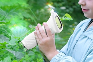 Little girl holding the WINWEND Microscope for Kids - Portable Handheld.