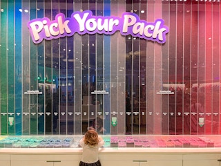 A child picking out crayons at the Crayola Experience location