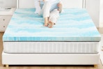 women sitting on top of mattress topper 