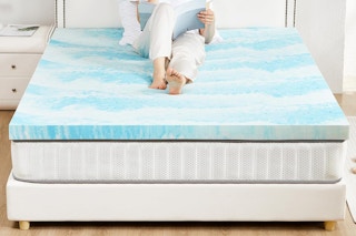 women sitting on top of mattress topper