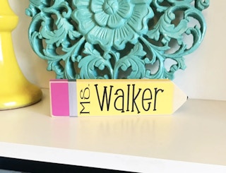 a sign that looks like a number 2 pencil with the name ms. walker on it