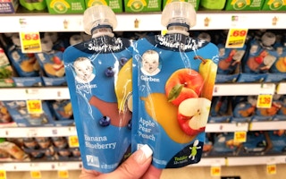 hand holding gerber baby food pouches at kroger
