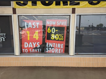 A buybuy Baby store window with a poster indicating 60-80% off