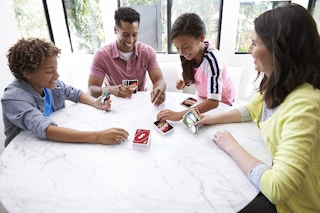 A family playing Uno Remix