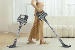the bottom half of a person using a cordless stick vacuum cleaner. Next to them is the same vacuum but shorter