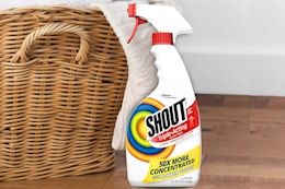 Shout Laundry Stain Remover Spray in front of laundry basket