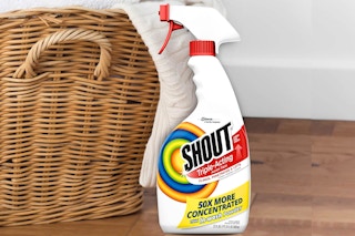 Shout Laundry Stain Remover Spray in front of laundry basket