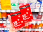 hand holding two neutrogena-acne-patches in walmart aisle