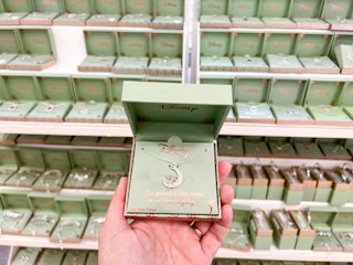hand holding up Disney Silver plated boxed jewelry