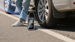 a tire inflator connected to a tire on the road