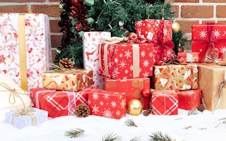 boxes of red and gold presents under a christmas tree