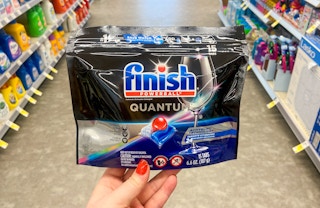 hand holding a pack of Finish Dishwashing tabs