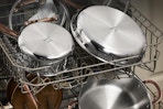 a stainless steel  pots and pans set on dishwashing racks