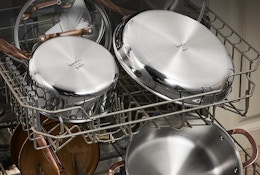 a stainless steel  pots and pans set on dishwashing racks