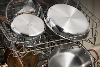 a stainless steel pots and pans set on dishwashing racks
