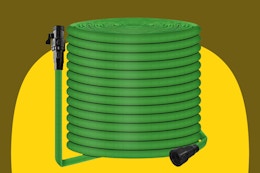 A green 50-foot garden hose is coiled. On each end is a standard 3/4 inch connector.