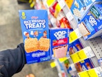 hand holding rice krispies and poptarts in cvs