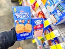 hand holding rice krispies and poptarts in cvs