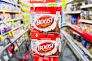 two boost drink packs in a cvs shopping cart in a store aisle