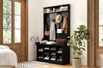 Lifestyle image of a black entryway bench with coat rack from Lowe's (in home setting)