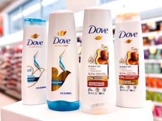 four bottles of dove hair care on store beauty counter