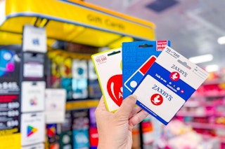 hand holding gift cards