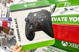 person holding a card for an xbox controller