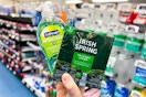 hand holding irish spring and softsoap products