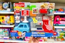 hand holding a little people target run playset in front of shelves