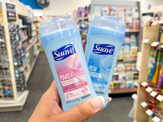 hand holding two Suave deodorants