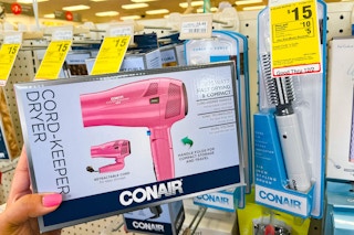 hand holding conair blow dryer next to sales tag