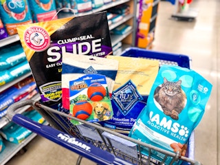 arm & hammer cat litter, blue buffalo treats and dog food, iams cat food, and chuck it balls in a cart
