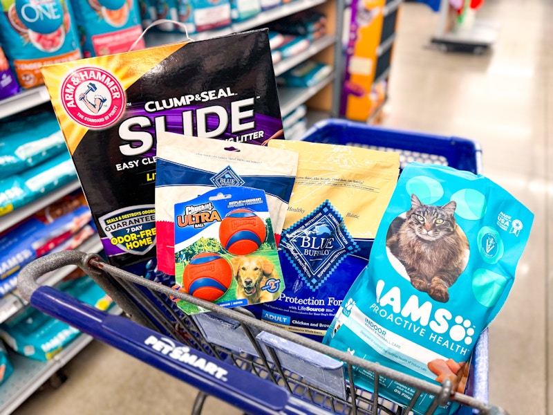 arm & hammer cat litter, blue buffalo treats and dog food, iams cat food, and chuck it balls in a cart