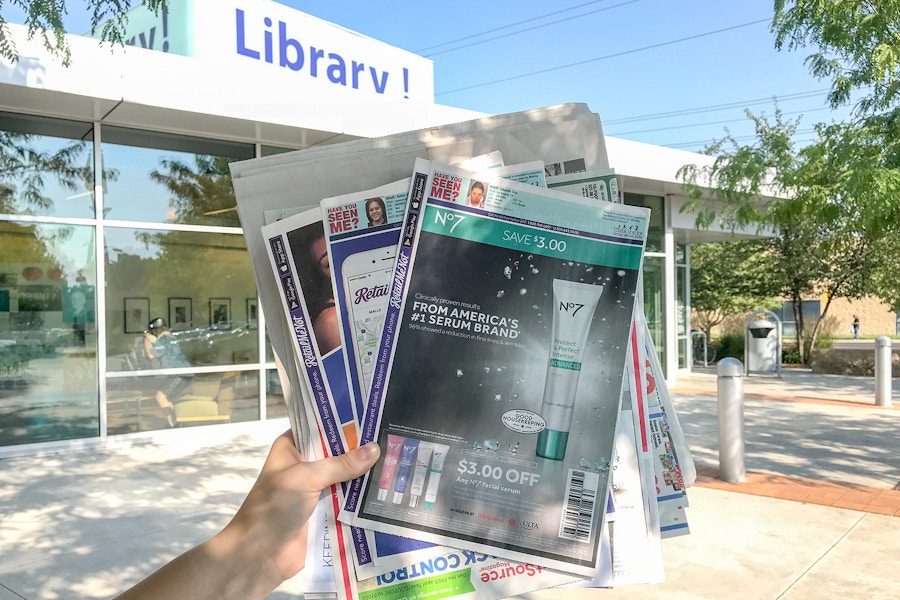 someone holding papers in front of library