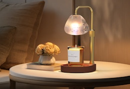 a candle warmer with a candle on a small table 