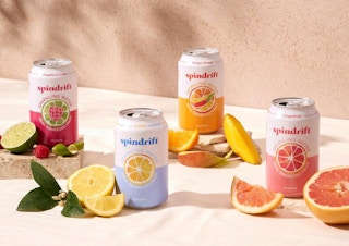 cans of sparkling water on a table with slices of fruit