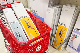 garment racks sitting in a target cart in front of a shelf