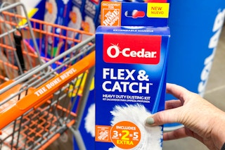 a box of o-cedar flex and catch dusting kit being held in front of a home depot cart