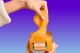 hand dipping into body scrub