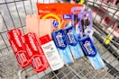 tide pods, monday conditioner, oral b toothbrushes, crest toothpaste, colgate toothpaste, and eucerin lotion in a cart