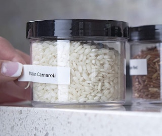 a white label being put on a jar